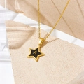 Gold star necklace featuring a black star pendant with letter A on a stone surface - Letter A Style (D112)