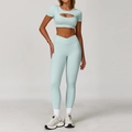 Two-piece light mint green yoga set with cutout crop top and cross waist leggings - S / Top And Bottom / Short Sleeve + Leggings / Cream Green