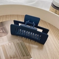 Matte navy blue rectangular shark hair claw clip displayed on a wooden tray - Matte Navy Blue Hollow Hair Claw