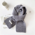 Thick grey knitted winter scarf for women with fashion label on white background - Gray