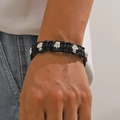Gothic punk black braided leather bracelet with silver skull charms on male wrist - Black Braided Leather Silver Metal Skull Bracelet