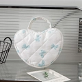 Heart-shaped quilted makeup bag in cream with blue bow pattern and top handle - White Background Blue Bow