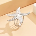 Minimalist adjustable silver starfish ring with textured wrap-around design on beige backdrop - J03303 / Silver