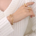 Golden titanium steel chain bracelet and heart arrow ring set on white sweater - Gold Chain Bracelet & Heart Ring-E307