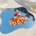 Macro shot of large colorful marbled acetate hair claw clip on a reflective mirror surface - Candy Color
