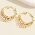 Detail of gold spiral coiled hoop earrings with fine metallic wire wrap texture - Heart Spring Spiral Hoop Style