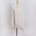 Detail of white flannel shawl featuring a plush faux rabbit fur collar and tassel hem - White