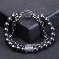 Detailed close-up of dark grey metal beaded bracelet with T-bar clasp on black box - Magnetic Hematite (Silver Chain)