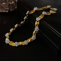 Close-up of vintage flower pearl earrings with metallic texture and drop silver needles - Gold Pearl Flower Necklace