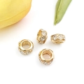 Golden spacers with sparkling rhinestones for DIY jewelry making on a fresh leaf background - Rhinestone Bead / KC Gold White Rhinestone