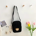 Cute black corduroy crossbody bag with a small brown bear patch and shoulder strap - Black