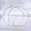 Minimalist 1.2mm large golden metal hoop earrings displayed on white silk fabric - 4cm / Gold