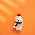 Cute white Christmas teddy bear keychain with red hat and striped knit scarf on orange background - White Bear Style A (Red Green Striped Scarf)