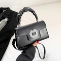Minimalist black leather crossbody bag with ruched handle and crystal buckle detail - Black