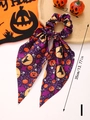Detail of Halloween hair scrunchie with pumpkin prints and long purple satin ribbons - Style I
