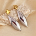 Two-tone heart earrings with gold top and silver drop pendant on silk background - Heart Stud with Olive Drop Earrings