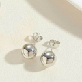 Detail of minimalist 14K gold-plated round stud earrings with polished mirror finish - Small / Silver