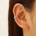 Elegant silver flower ear cuff with zircon stones on female model's ear cartilage - Silver Flower Zircon Style (8567)