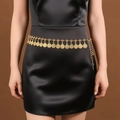 Detail of bohemian gold metal waist chain with vintage coin charms on black dress - Round Coin Disc / Antique Gold