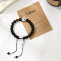 Detail of Libra beaded bracelet with matte black beads, tiger eye stone and silver charm - Libra
