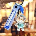 Portachiavi astronauta blu con cinturino Dream On e ciondoli a forma di razzo - Astronauta dell'Oceano Blu - Viso Giallo in Piedi