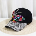 Close-up of a black denim baseball cap with rhinestone butterfly and studded brim - Style 30-Black Multicolor Rhinestone Butterfly