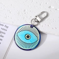 Macro shot of large round Evil Eye pendant with bohemian tribal geometric patterns - Round Eyelash Eye