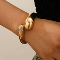 Golden open cuff bracelet with polished teardrop end and multi-row zircon accents - Water Drop + Rhinestone Open Bangle (A-822) / KC Gold
