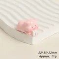 Macro shot of cute pink resin pig figurine with 22x35x22mm dimensions and 11g weight - Milk Drinking Pink Pig
