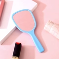 Portable light blue handheld makeup mirror for women on a soft pink background - Sky Blue