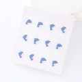 Close-up of twelve blue glitter dolphin stud earrings neatly arranged on a white card - 6 Pairs Set / Light Blue