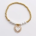 Golden stretch heart bracelet with white pearls and smiling face pendant for women - White