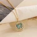 Elegant gold oval pendant necklace with teal bow and rhinestone frame on white fabric - Round Teal Bowknot