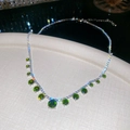 Detail of silver necklace with green round gemstones and sparkling zircon fringe design - Necklace - Silver - Green
