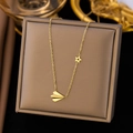 Golden paper plane and star charm necklace displayed on a premium jewelry box - Paper Airplane Necklace / Gold