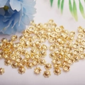 Detailed close-up of 14K gold hollow flower bead caps for DIY jewelry making crafts - 6mm Flower Cap / 14K Gold