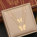 Detail of gold double-layer necklace featuring pink butterfly pendants on a jewelry box - 1# Double Layer Butterfly Necklace