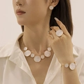 Detail view of model wearing white enamel gold necklace and matching jewelry set - Necklace+Bracelet+Ring+Earrings