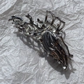 Detail shot of silver liquid metal hair claw with irregular 3D butterfly design - No. 2 Long Butterfly (Silver)