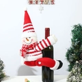 Close-up of a festive knitted snowman wine bottle cover with red striped hat and scarf - Snowman