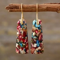 Detail of bohemian drop earrings with colorful mosaic stone textures on wood branch - Patterned Trapezoid