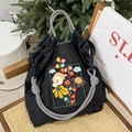 Detail of floral embroidery on a black nylon tote bag with woven shoulder straps - M / Black Frame Flowers (Without Shoulder Strap)