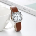 Detail view of square silver watch case with white dial and brown leather strap - Coffee