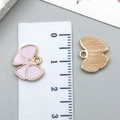Pink enamel butterfly charm in alloy metal with size reference on a white ruler - Small KC Gold Pink Bowknot