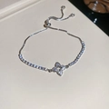 Macro view of adjustable silver bracelet with zircon flower charm and tennis chain detail - Silver Flower
