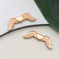 DIY jewelry charm accessory featuring rose gold wing heart pendants on white paper - Wing Spacer Bead