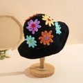 Handmade black knit bucket hat with colorful 3D crochet flowers on a wooden stand - One Size / Colorful Daisy Hat