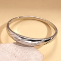 Detail view of silver geometric bangle with crystal diagonal stripes on natural stone - Silver