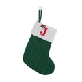 Detail of green knitted Christmas stocking with white cuff and red letter J embroidery - Letter J