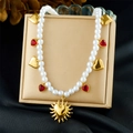 Close-up of gold heart pendants and white pearls on an elegant collarbone necklace - Multi Heart Sun Pendant Style (N3736)
